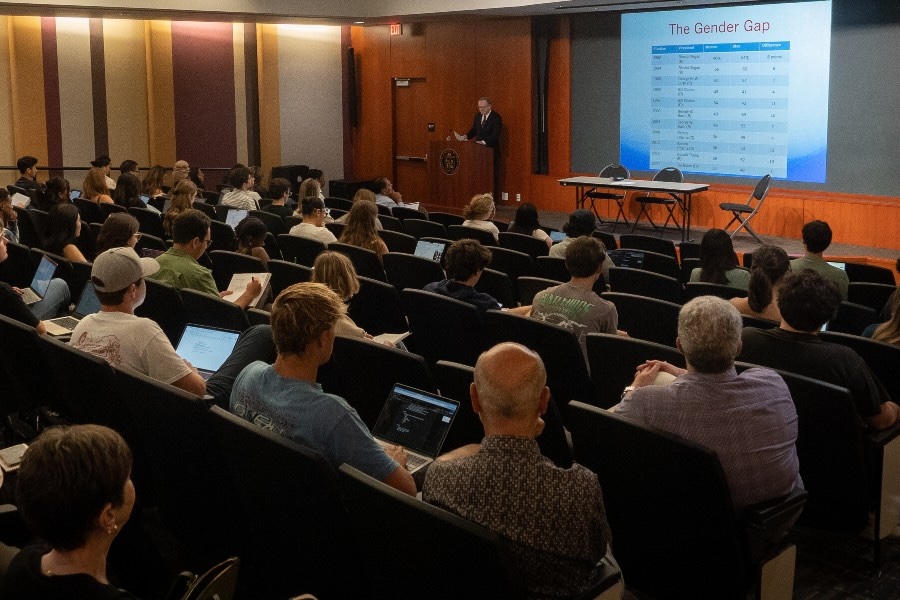 professor giving lecture to students in auditorium